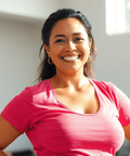 Happy woman in a pink workout shirt, reflecting energy and fitness improvements from Weight-loss Accelerator Extract.